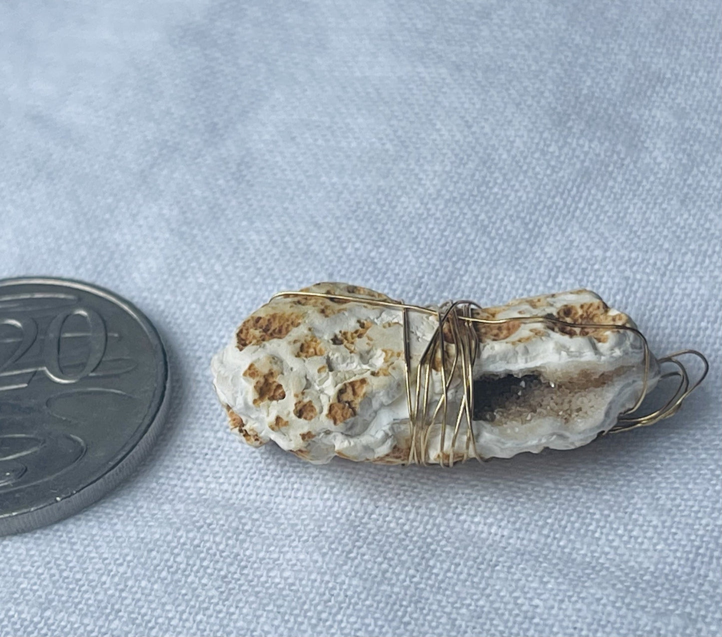 Light coffee-coloured geode pendant with textured earthy tones and subtle sparkles