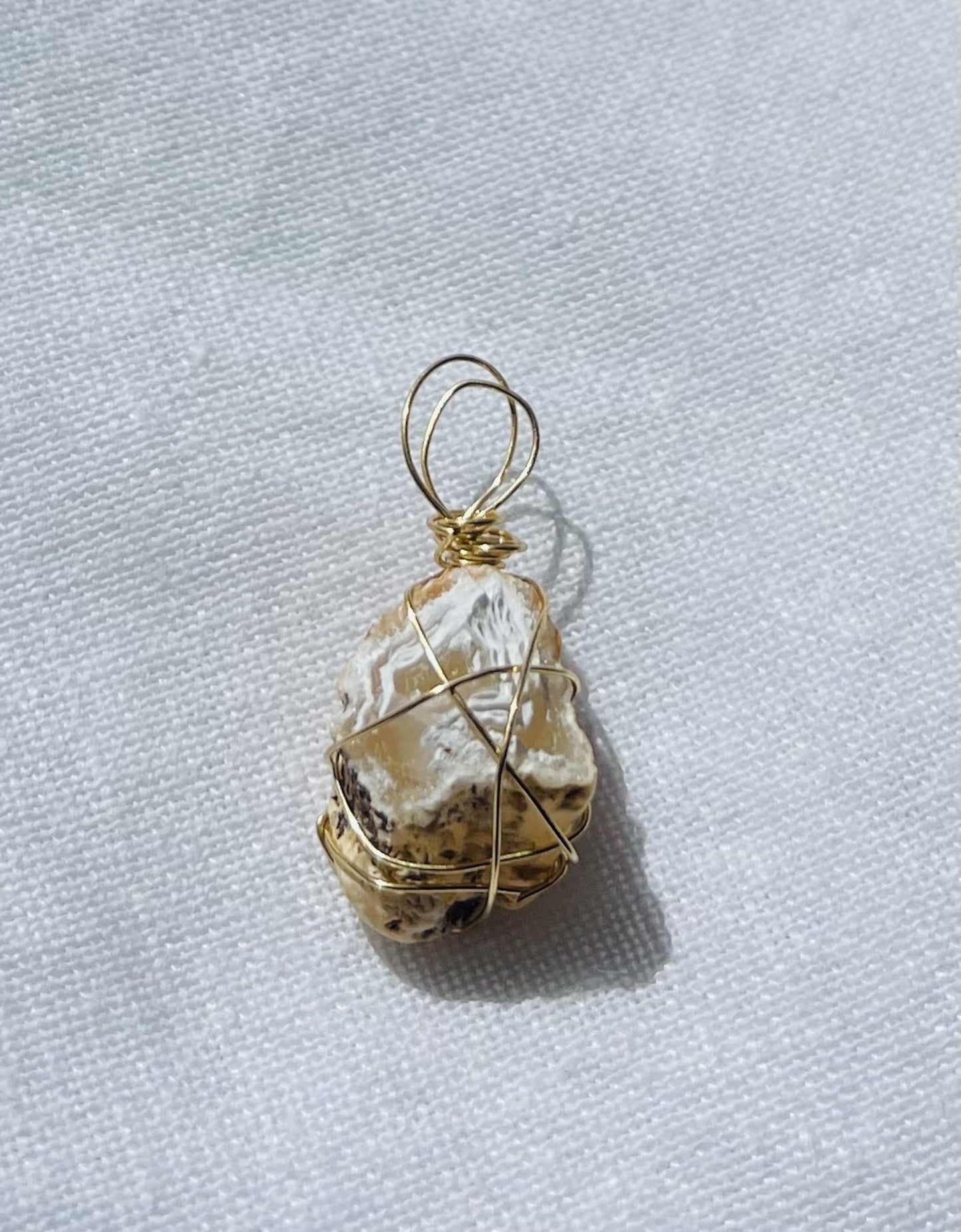Lemon-coloured geode wrapped in gold-coloured tarnish-resistant wire