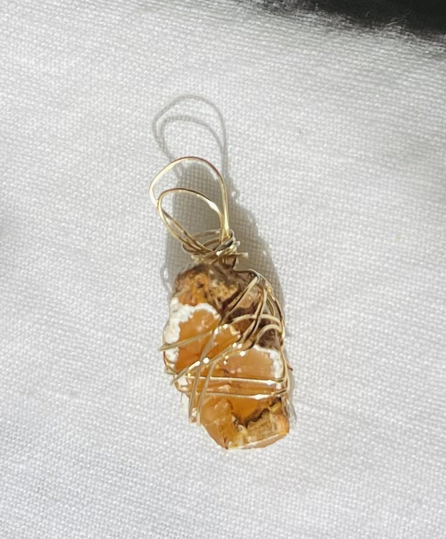Orange agate pendant with a honey-toned exterior and gold-coloured wire - WR-00020
