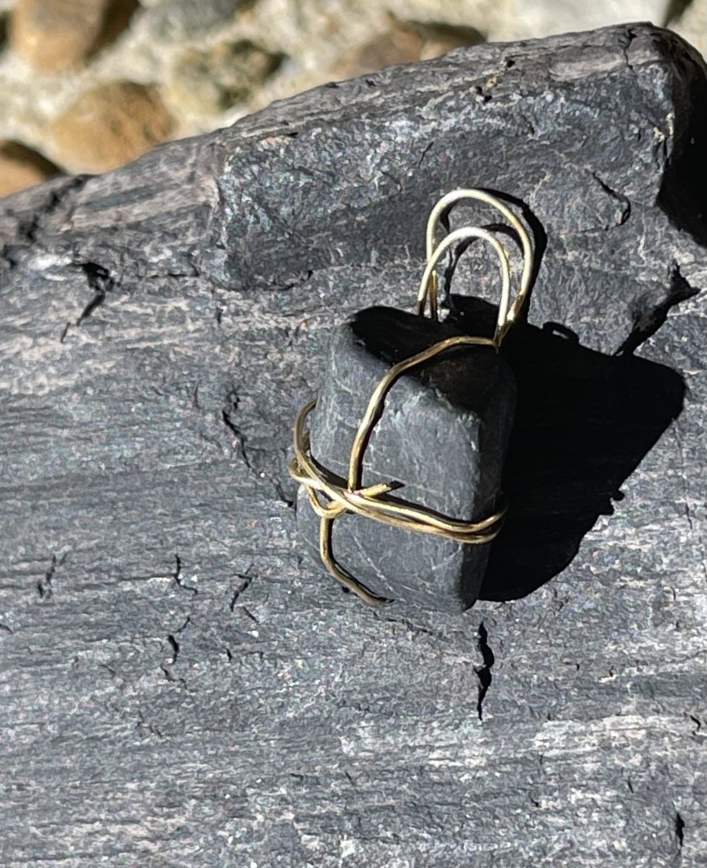 Black charm with gold-coloured accents