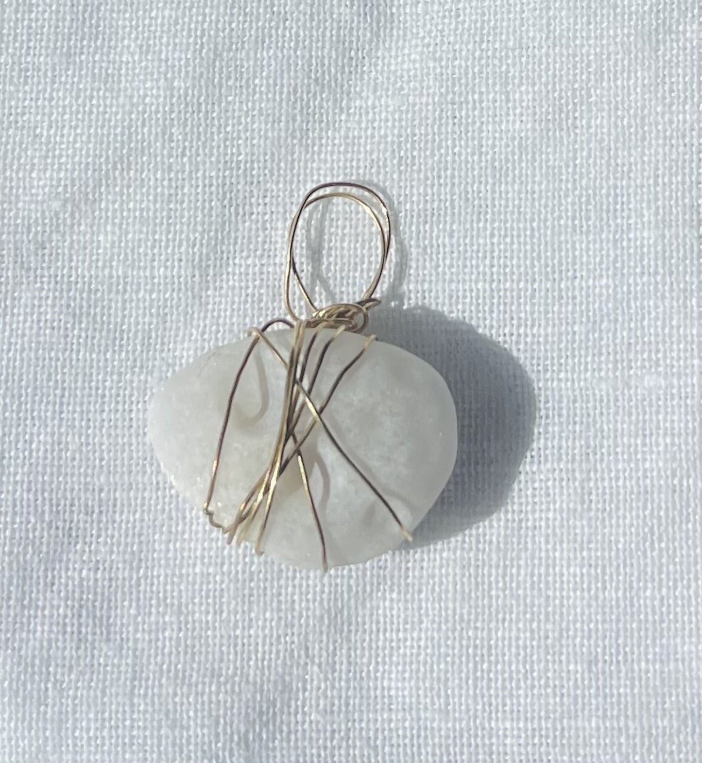 Oval-shaped charm with circular patterns and translucent finish