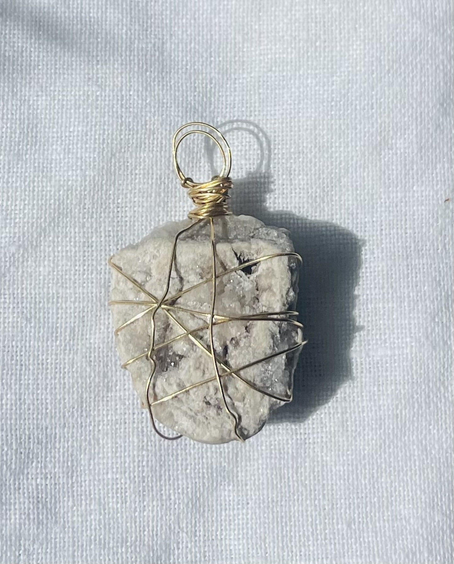 Sparkling pendant with shield-like design