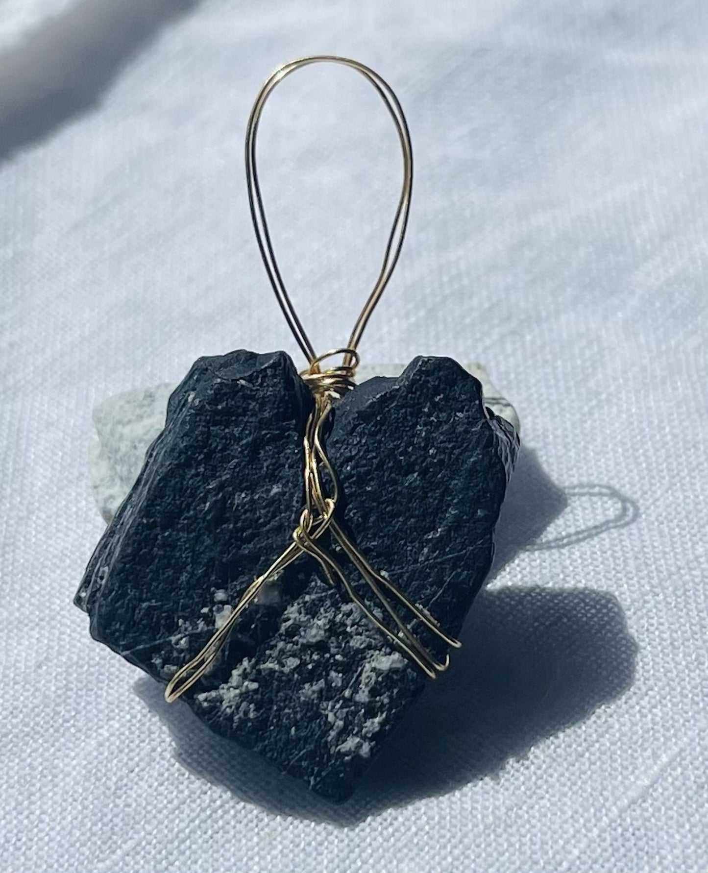 Heart-shaped pendant with golden hues and sparkly finish