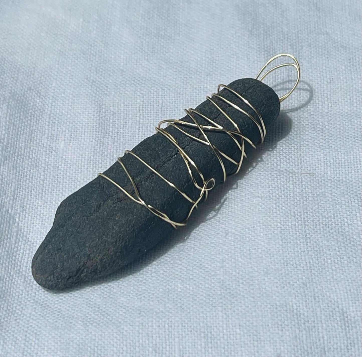 Bold black charcoal pendant with a textured surface