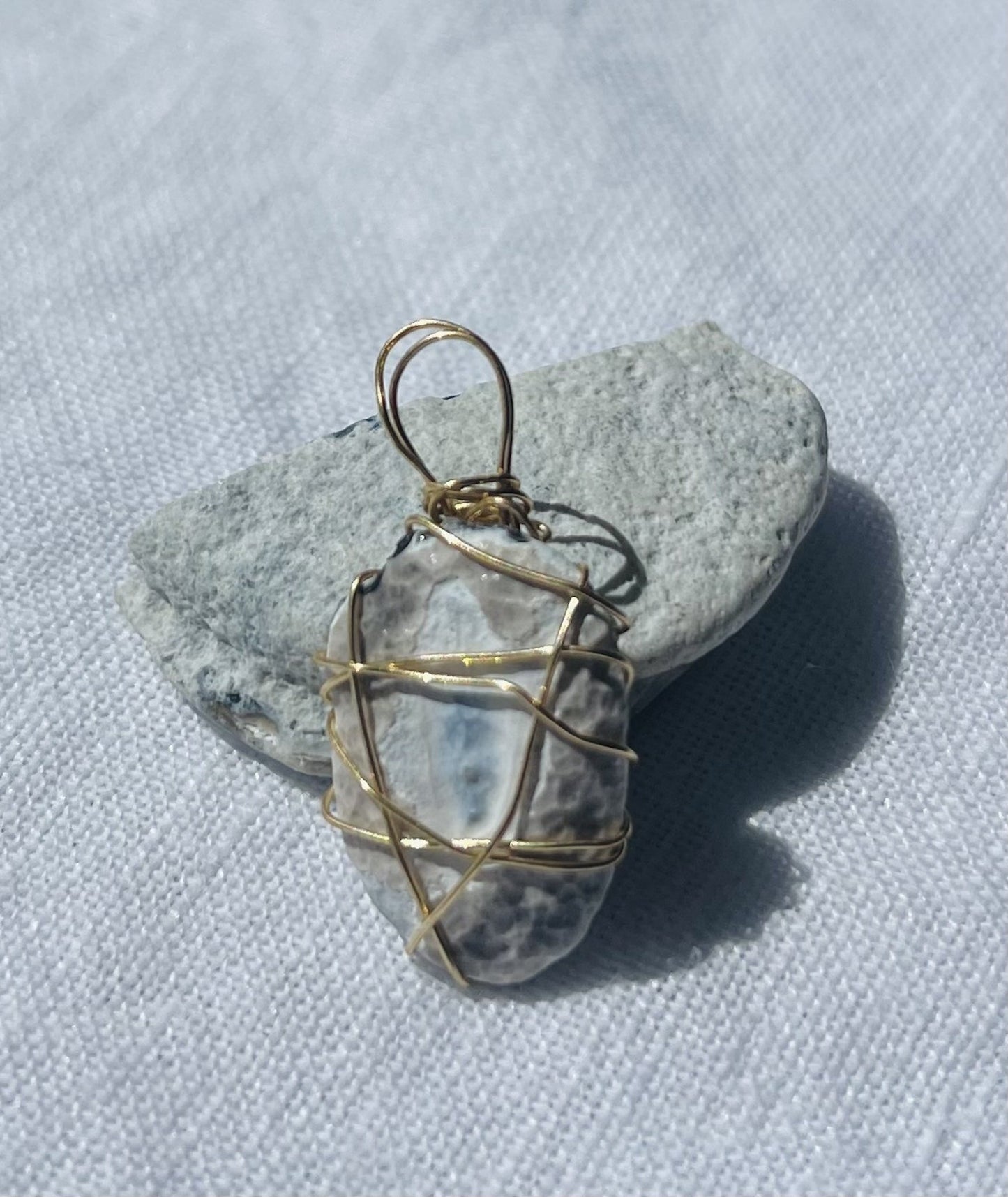 Navy and white pendant with unique otherworldly design