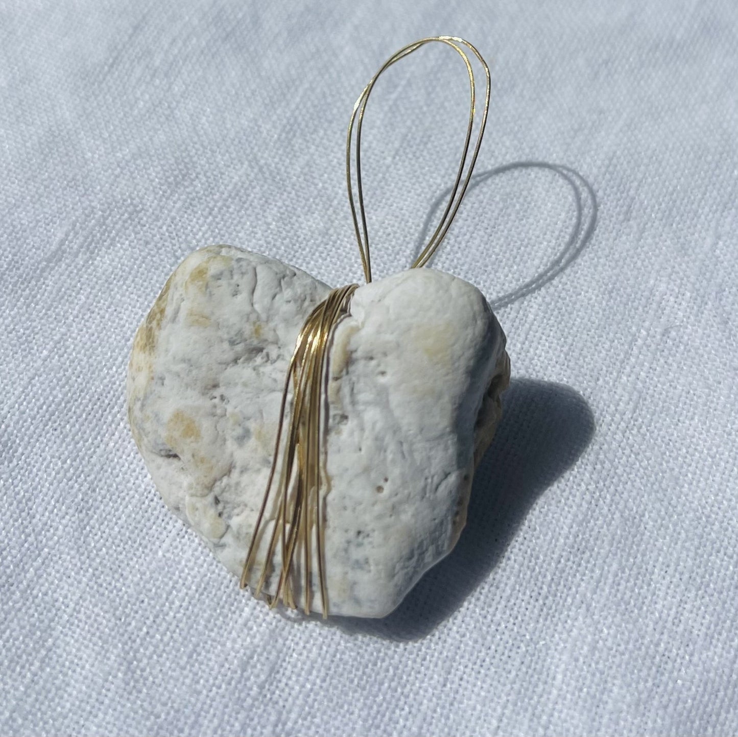 Grey loveheart-shaped pendant with gold and rust accents