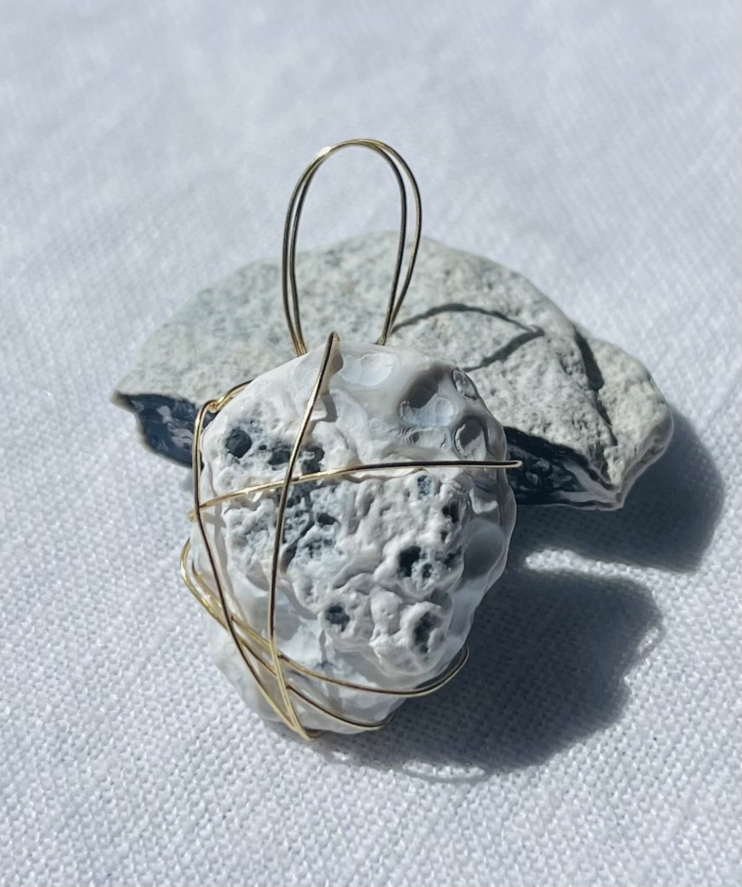 Navy and white stone pendant with lunar-inspired patterns