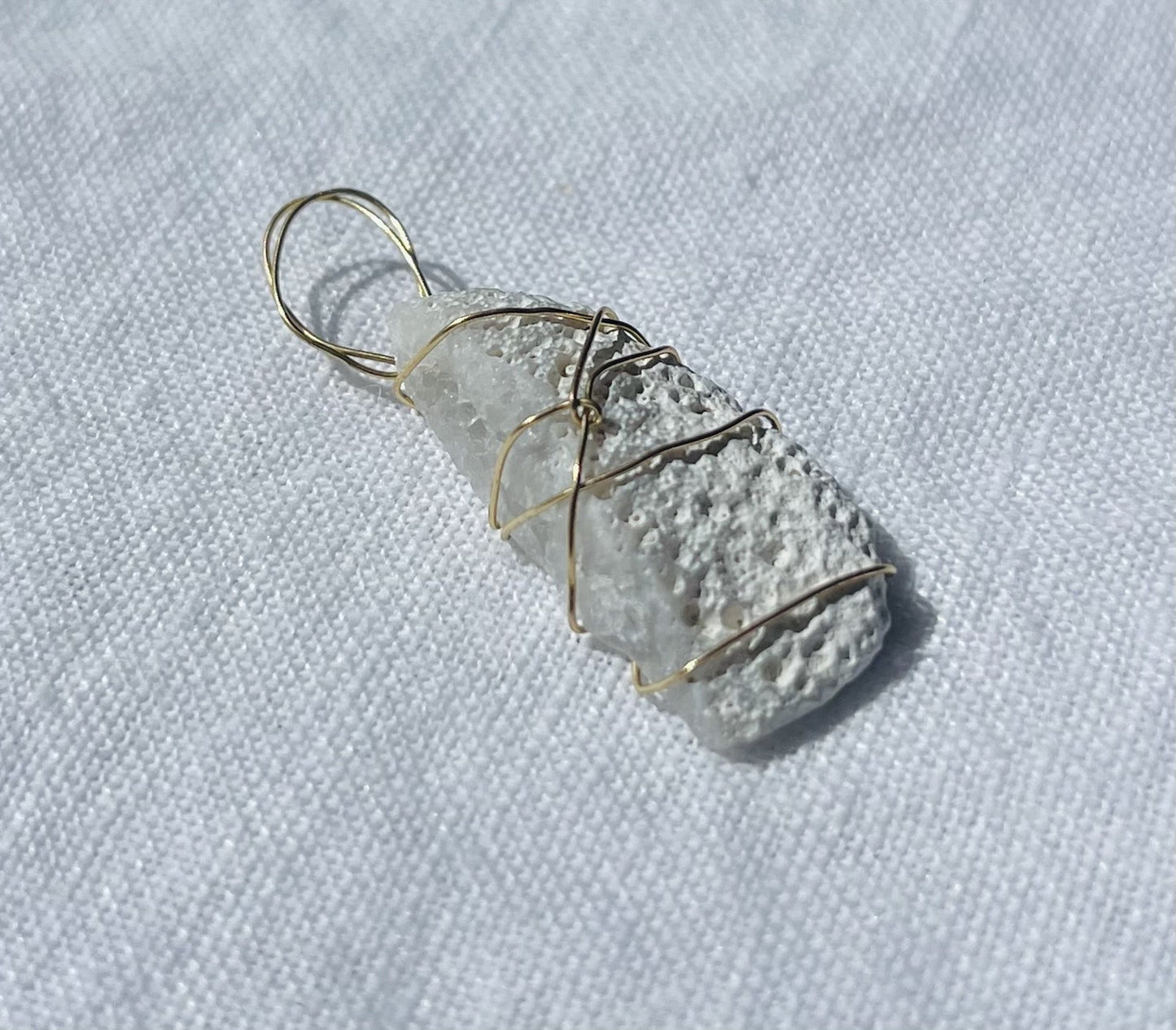 Cosmic-inspired pendant with side sparkles and otherworldly design