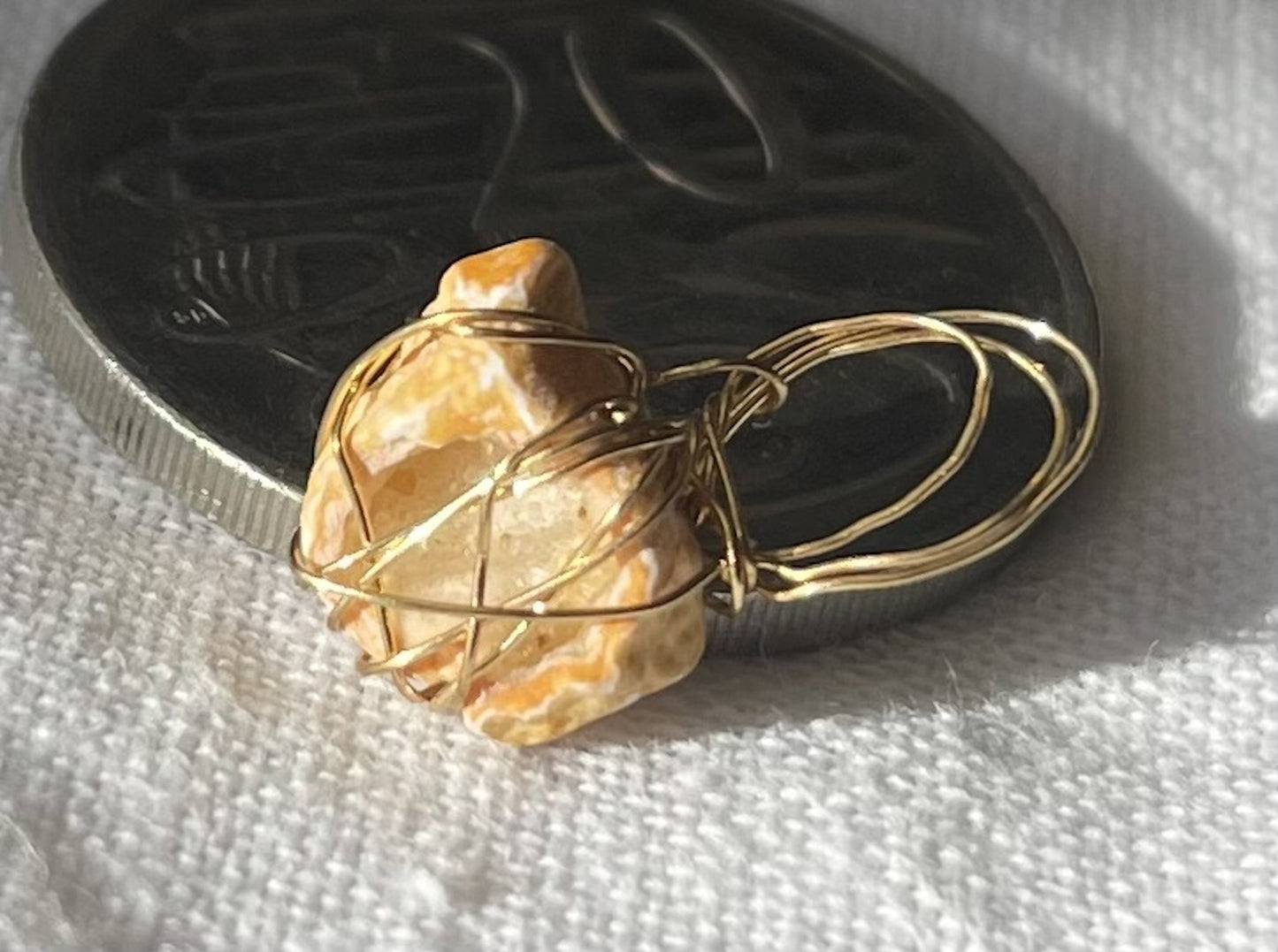 Round geode with brilliant sparkles wrapped in tarnish-resistant wire