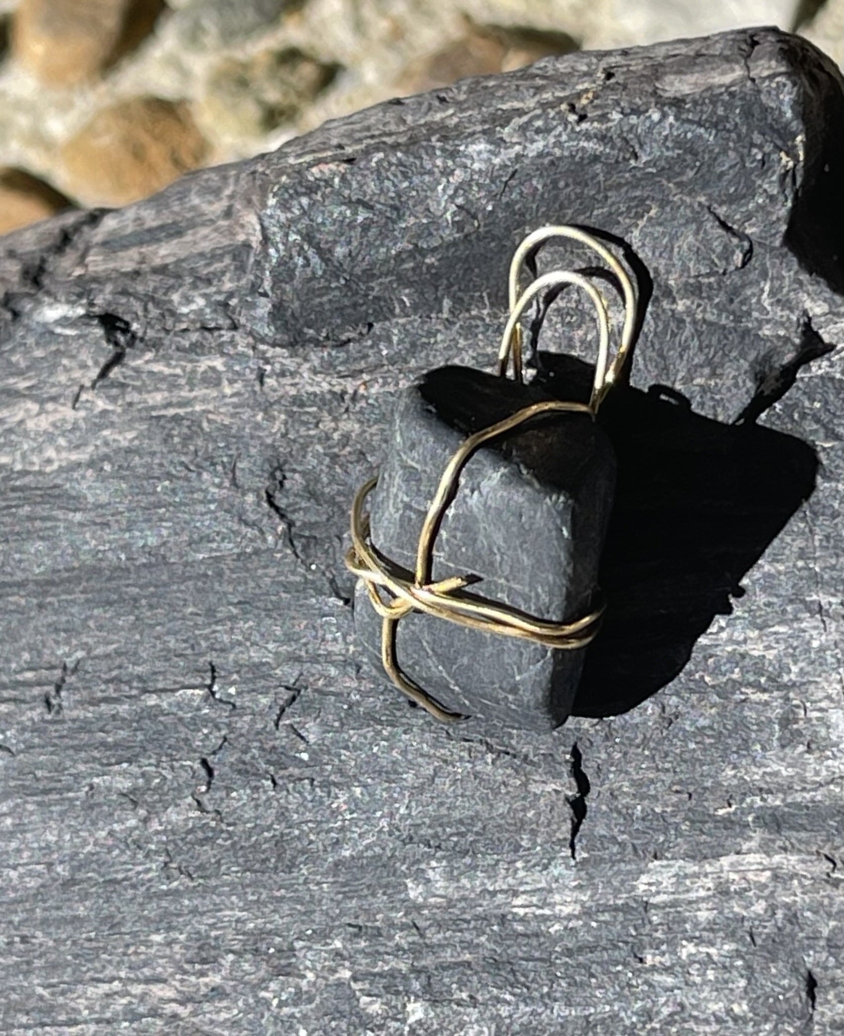 Black charm with gold-coloured accents