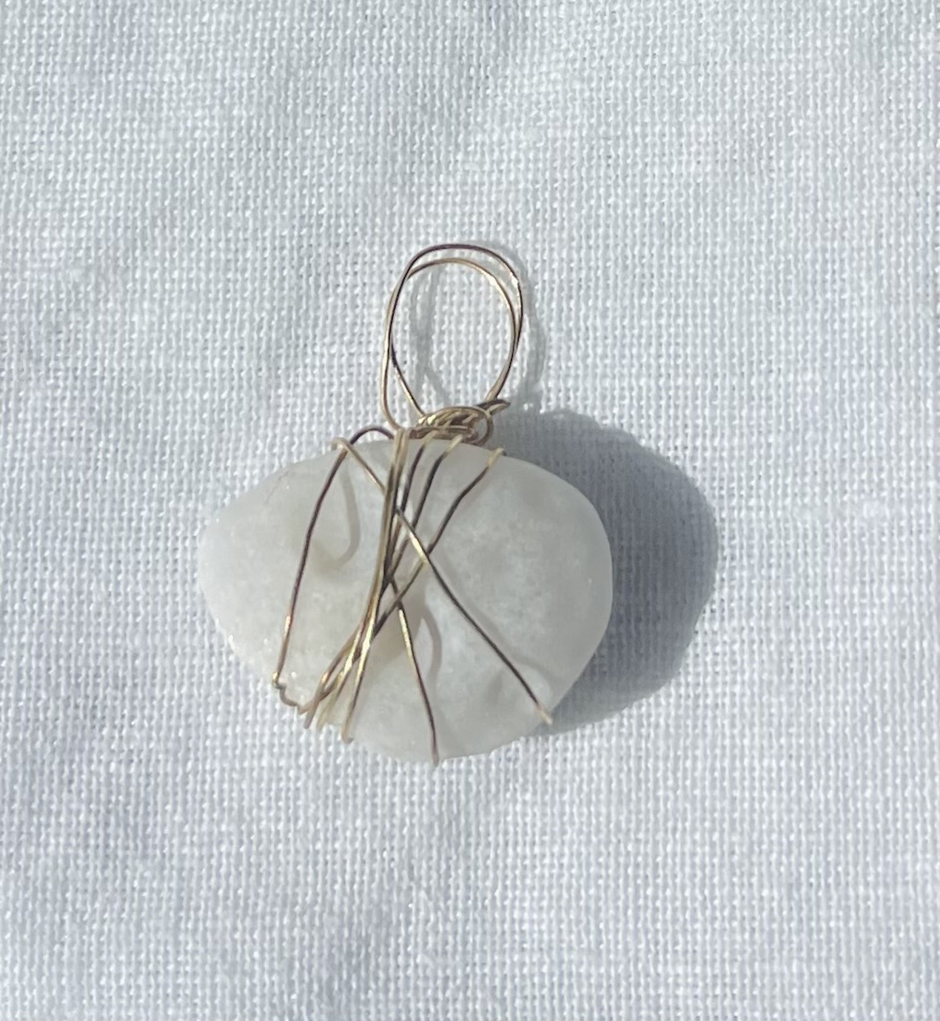 Oval-shaped charm with circular patterns and translucent finish