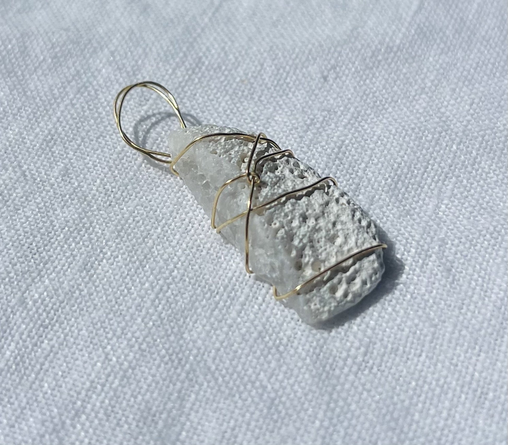 Cosmic-inspired pendant with side sparkles and otherworldly design